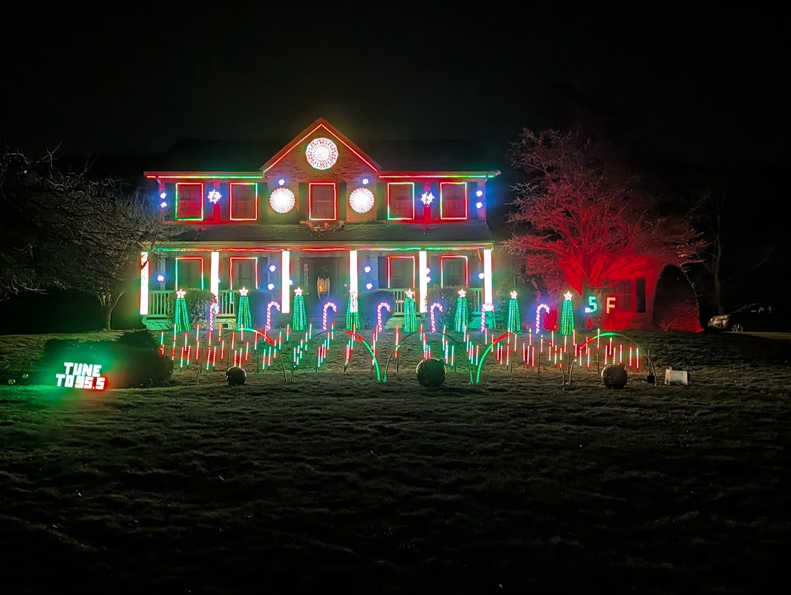 Christmas light show with pixel trees, candy canes, and a fully outlined house
